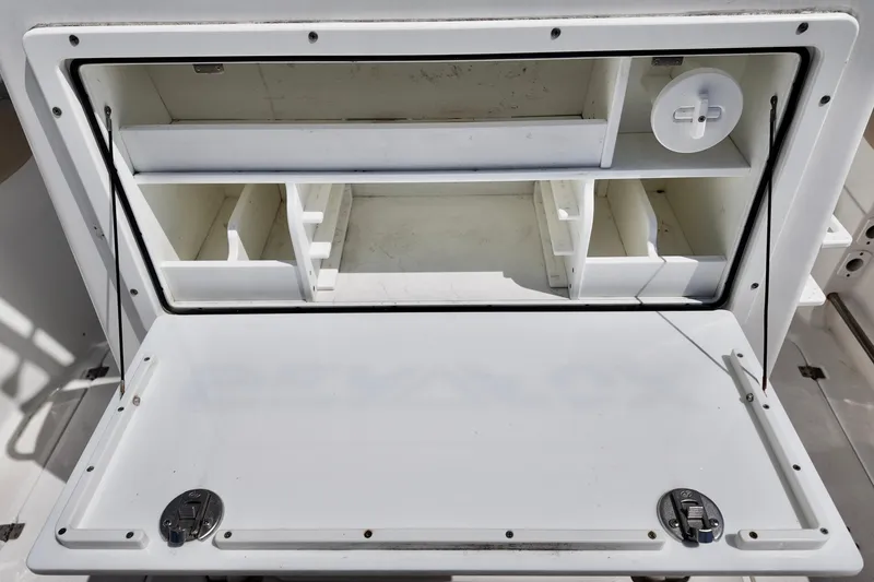 Slide: The Image of Storage compartment on a 2017 Sea Fox 288 Commander boat, featuring organized shelves and secure latches. - 7