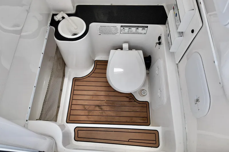 Slide: The Image of 2017 Sea Fox 288 Commander boat bathroom with wooden floor and compact toilet. - 9