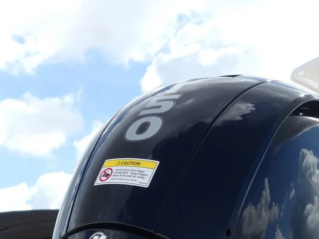 Slide: The Image of Close-up of a 50 HP outboard motor under blue sky. - 10