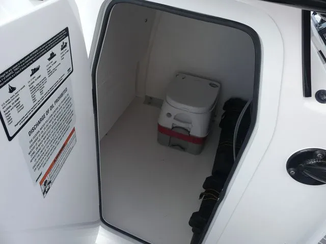 Slide: The Image of Interior of Twin Vee 240 GFX2 2027 with portable toilet. - 18