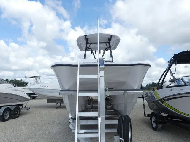 Slide: The Image of 2027 Twin Vee 240 GFX2 boat on trailer, blue sky. - 2
