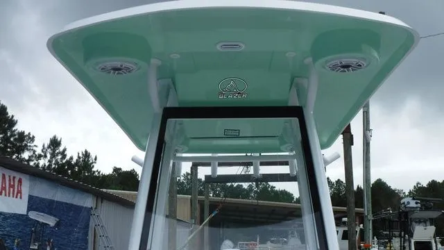 Slide: The Image of 2026 Blazer Bay 2440 boat with green roof and speakers. - 13