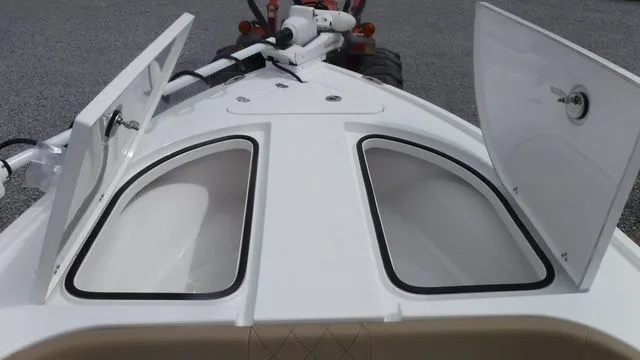 Slide: The Image of 2026 Blazer Bay 2440 boat with open storage compartments. - 7