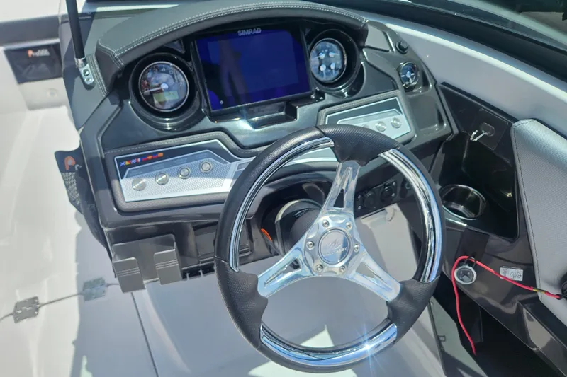 Slide: The Image of 2024 Monterey 215SS Super Sport boat dashboard with steering wheel and control panel. - 19