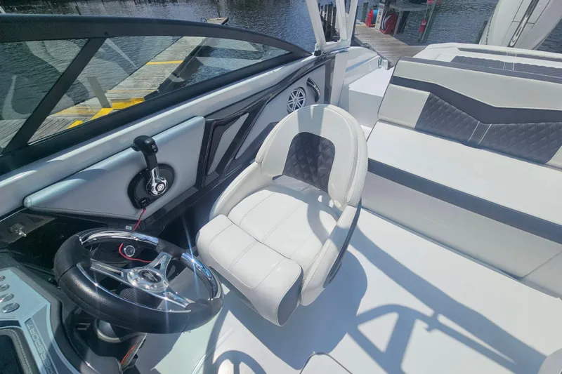 Slide: The Image of 2024 Monterey 215SS Super Sport boat interior with steering wheel and seating. - 20