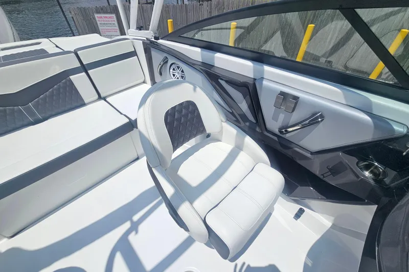 Slide: The Image of 2024 Monterey 215SS Super Sport boat interior with white seating and sleek design. - 21