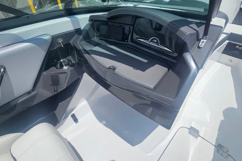 Slide: The Image of Interior view of 2024 Monterey 215SS Super Sport boat, featuring sleek dashboard and seating. - 22