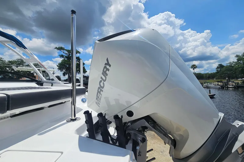 Slide: The Image of 2024 Monterey 215SS Super Sport boat with Mercury engine, docked under a cloudy sky. - 7