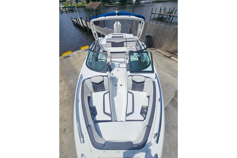 Slide: The Image of 2024 Monterey 215SS Super Sport boat with sleek design and spacious seating at a dock. - 9