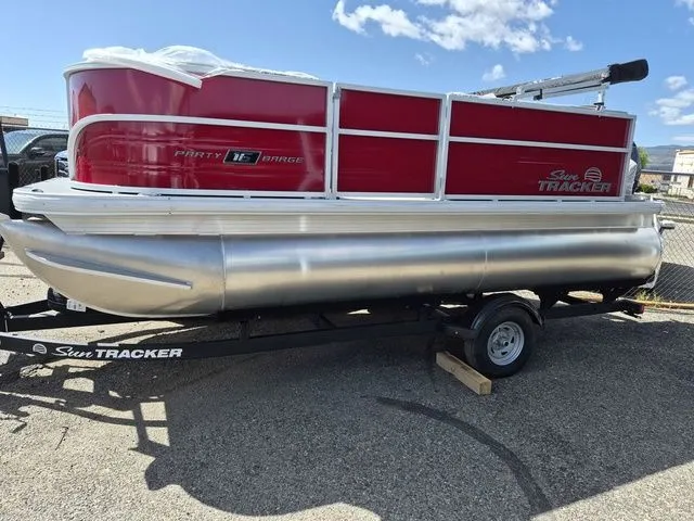Slide: The Image of 2026 Sun Tracker Party Barge 16 DLX on trailer, red design. - 3