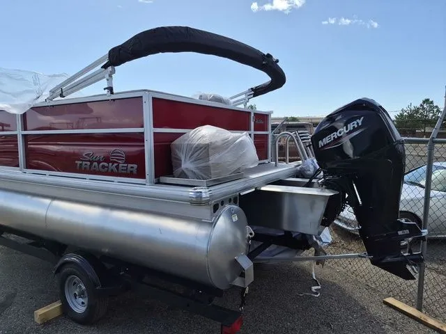 Slide: The Image of Sun Tracker Party Barge 16 DLX 2026 with Mercury engine, side view. - 8