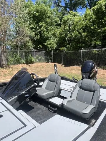 Slide: The Image of 2026 Xpress Boats HYPER-LIFT H18C with gray seats outdoors. - 6