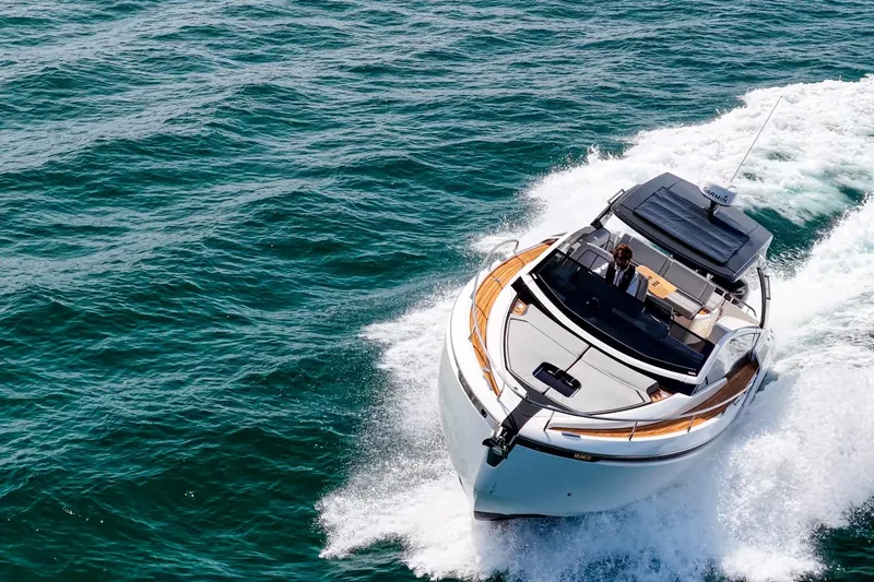 Slide: The Image of 2023 Fairline F//Line 33 Outboard cruising on open water, showcasing sleek design and performance. - 10