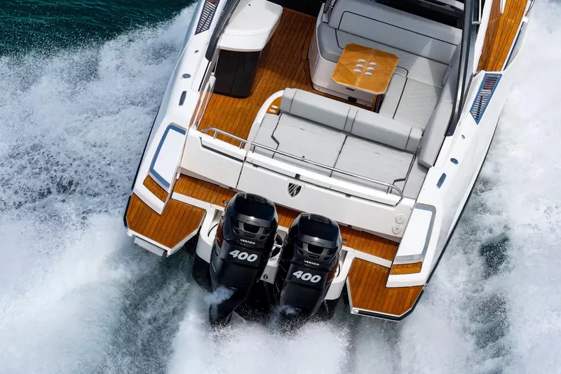 Slide: The Image of 2023 Fairline F//Line 33 Outboard cruising with twin engines, featuring sleek design and luxury seating. - 14