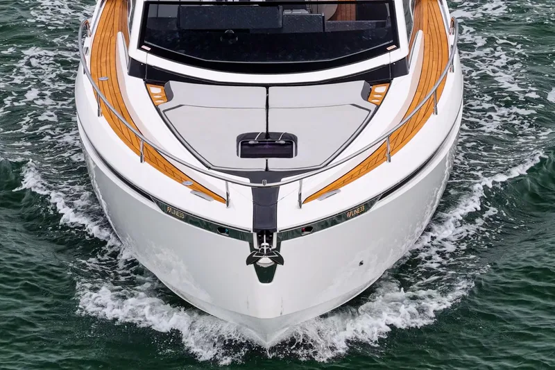 Slide: The Image of 2023 Fairline F//Line 33 Outboard cruising on water, showcasing sleek design and wooden accents. - 25