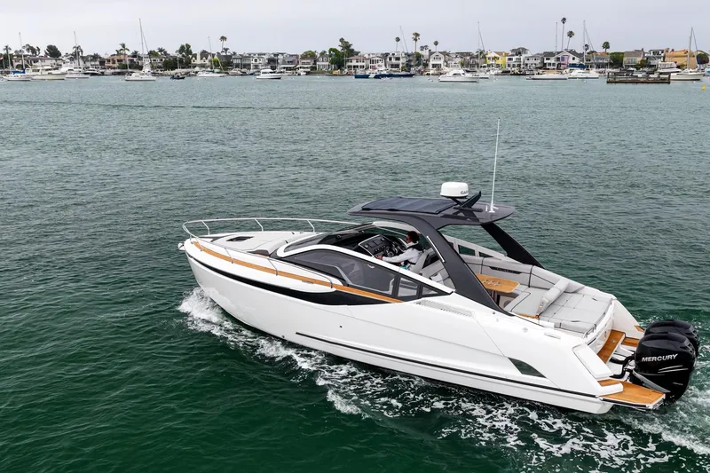 Slide: The Image of 2023 Fairline F//Line 33 Outboard cruising on a scenic waterfront. - 26