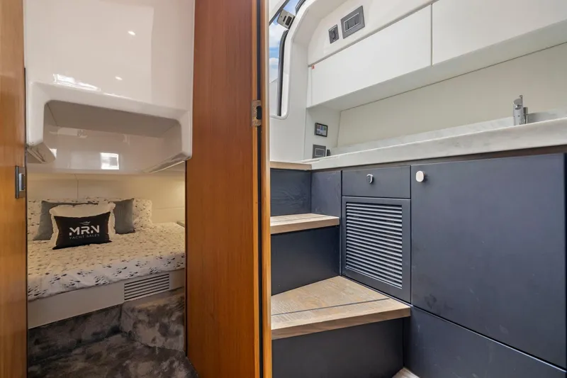 Slide: The Image of Interior of 2023 Fairline F//Line 33 Outboard yacht, featuring cozy cabin and modern kitchenette. - 60