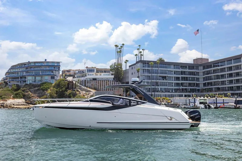 Slide: The Image of 2023 Fairline F//Line 33 Outboard yacht cruising near modern waterfront buildings. - 7