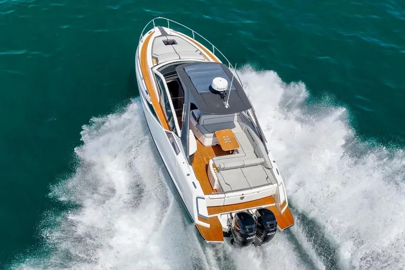 Slide: The Image of The 2023 Fairline F//Line 33 Outboard speeds across the water, featuring sleek design and a luxurious deck. - 8