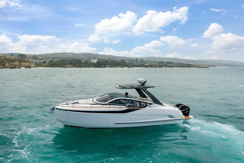 Slide: The Image of 2023 Fairline F//Line 33 Outboard cruising on a scenic coastal waterway. - 84