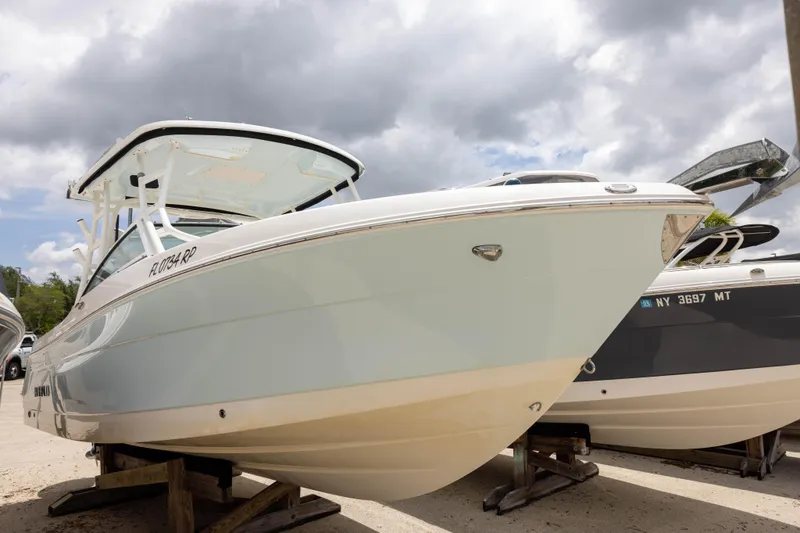 The Image of 2018 Robalo R247 Dual Console boat on display under cloudy skies. - 0