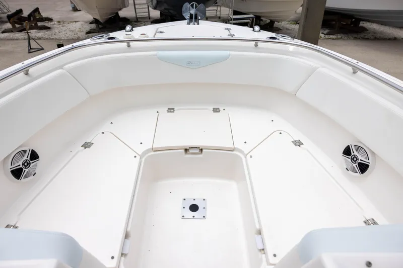 Slide: The Image of 2018 Robalo R247 Dual Console boat interior with seating and storage compartments. - 10