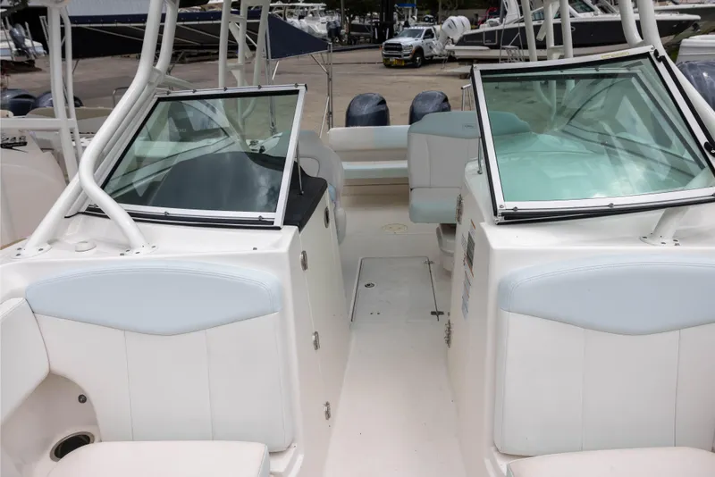 Slide: The Image of 2018 Robalo R247 Dual Console boat interior with seating and windshield. - 13