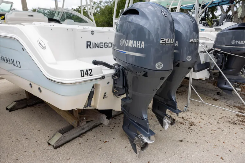 Slide: The Image of 2018 Robalo R247 Dual Console boat with twin Yamaha 200 engines on display. - 2