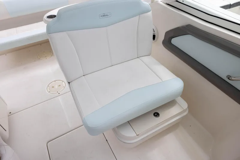 Slide: The Image of 2018 Robalo R247 Dual Console boat seat with white and light blue upholstery. - 9
