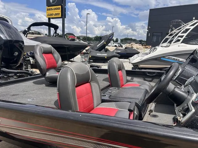 Slide: The Image of 2019 Ranger RT198P boat with red seats displayed outdoors. - 4