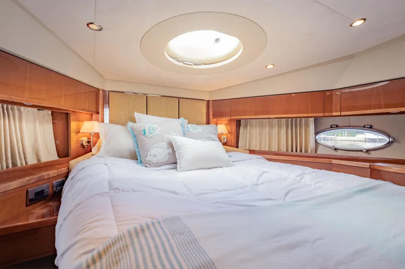 Slide: The Image of Luxurious bedroom interior of 2009 Princess 54 Flybridge yacht with elegant wood finishes. - 56