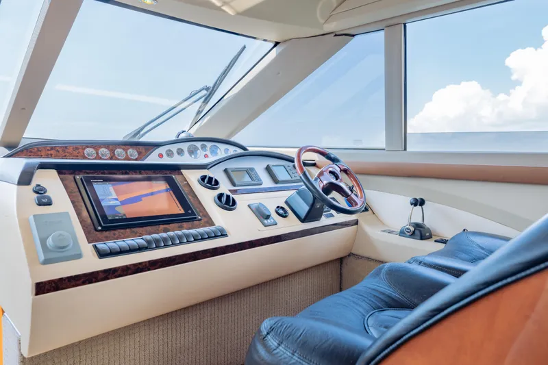 Slide: The Image of Luxurious helm of 2009 Princess 54 Flybridge yacht with modern navigation controls. - 41