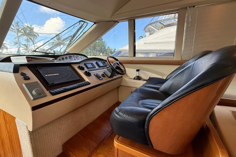 Slide: The Image of Luxurious helm of 2009 Princess 54 Flybridge yacht with leather seating and advanced navigation controls. - 10