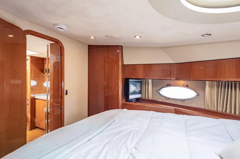 Slide: The Image of Luxurious cabin interior of 2009 Princess 54 Flybridge yacht with wood finishes and porthole window. - 58
