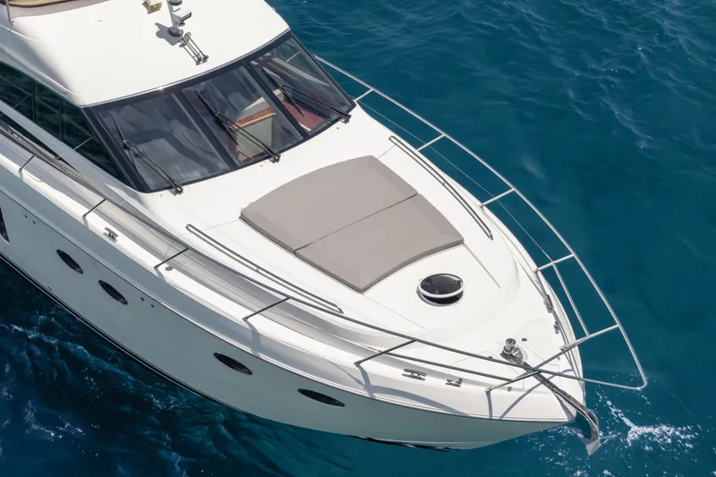 Slide: The Image of 2009 Princess 54 Flybridge yacht cruising on clear blue water. - 24