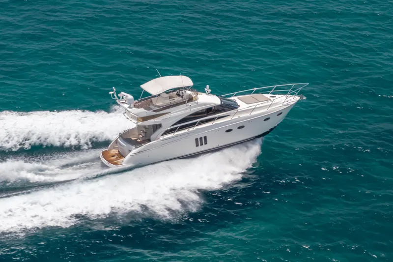 Slide: The Image of 2009 Princess 54 Flybridge yacht cruising on open blue sea. - 15