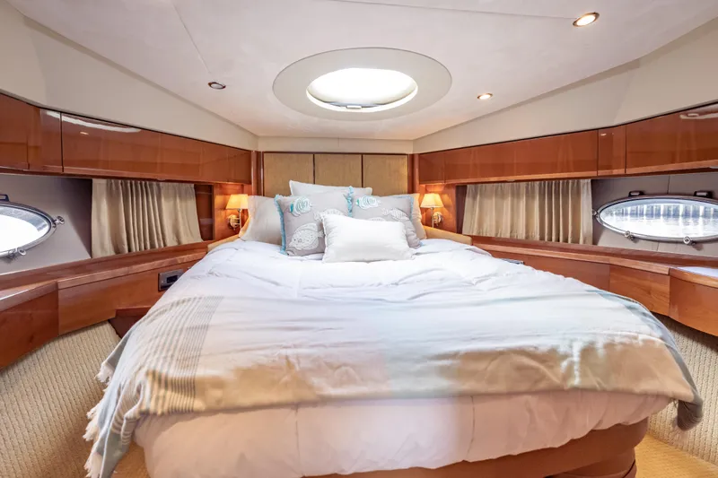 Slide: The Image of Luxurious bedroom interior of 2009 Princess 54 Flybridge yacht with elegant wood finishes. - 57
