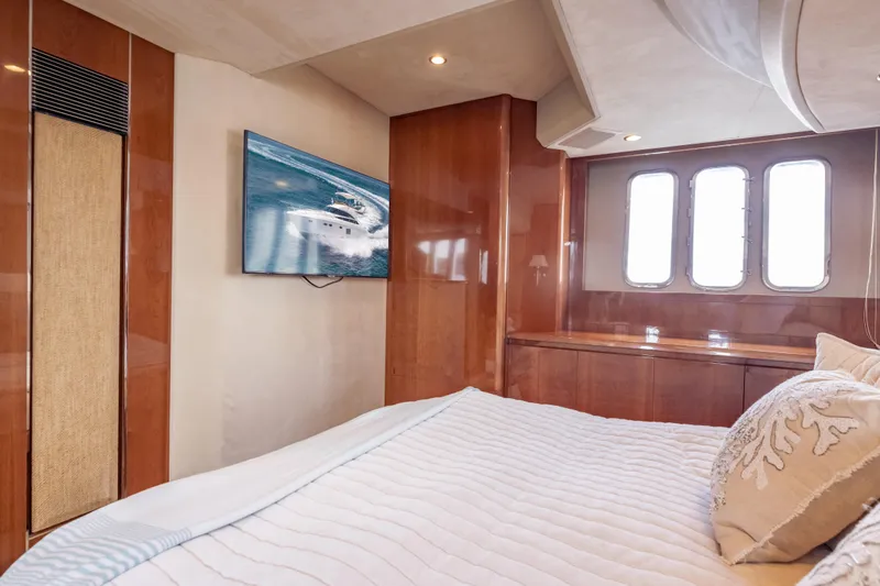 Slide: The Image of Luxurious bedroom interior of 2009 Princess 54 Flybridge yacht with elegant wood paneling. - 55