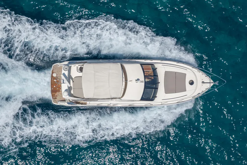 Slide: The Image of Aerial view of 2009 Princess 54 Flybridge yacht cruising on blue ocean waters. - 9