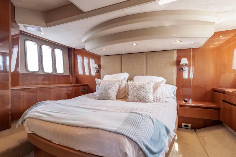 Slide: The Image of Luxurious bedroom interior of 2009 Princess 54 Flybridge yacht with elegant wood paneling. - 52