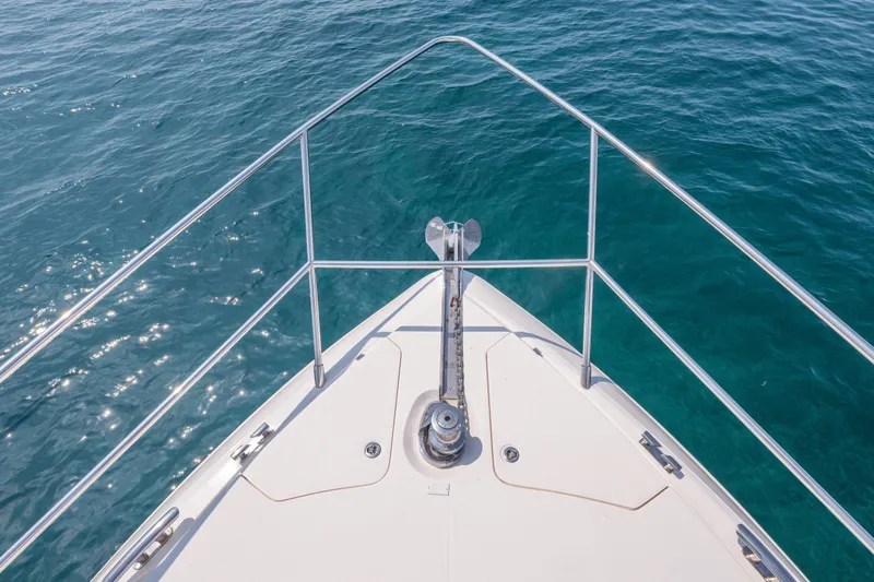 Slide: The Image of Bow view of 2009 Princess 54 Flybridge yacht on clear blue water. - 31