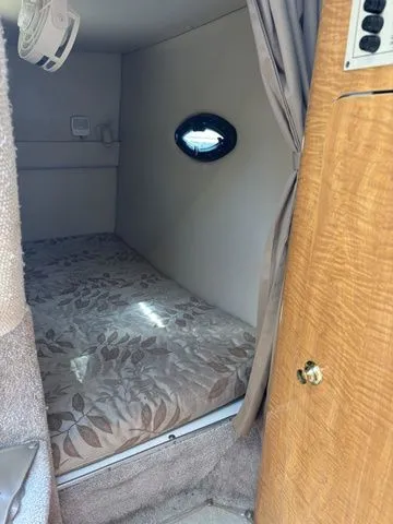 Slide: The Image of Interior of a 2002 Regal Commodore 2765 yacht with sleeping area. - 12