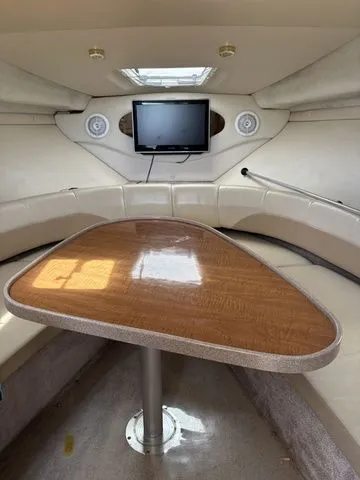 Slide: The Image of Interior of 2002 Regal Commodore 2765 with table and TV. - 15