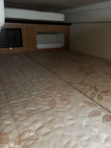 Slide: The Image of Interior of 2002 Regal Commodore 2765 yacht with cushioned bed. - 21