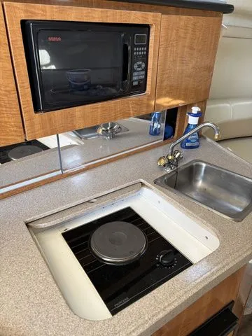 Slide: The Image of Galley in 2002 Regal Commodore 2765 boat with microwave and sink. - 22
