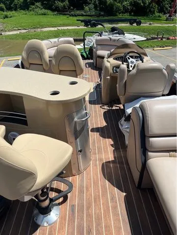 Slide: The Image of Interior of a 2015 Berkshire 250E pontoon boat with beige seating. - 9