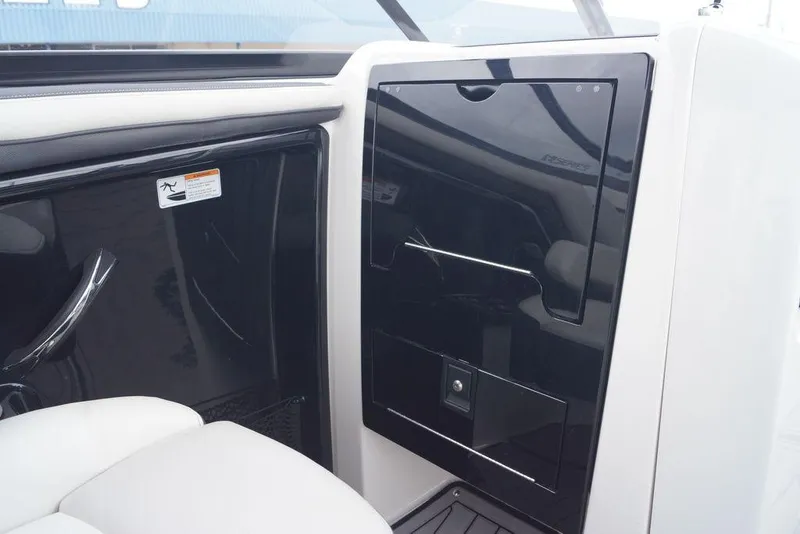 Slide: The Image of Interior view of a 2018 Yamaha Boats 242 Limited S, featuring sleek black and white design. - 12