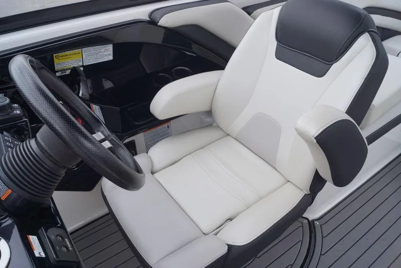 Slide: The Image of 2018 Yamaha Boats 242 Limited S cockpit with luxury seating and steering wheel. - 17