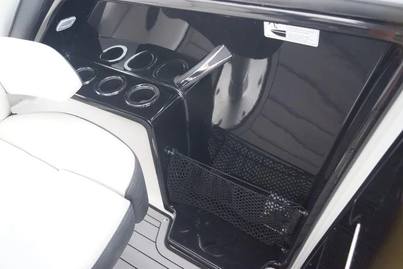 Slide: The Image of Interior of 2018 Yamaha Boats 242 Limited S with cup holders and storage net. - 18