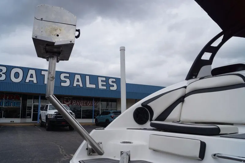 Slide: The Image of 2018 Yamaha Boats 242 Limited S at boat sales dealership under cloudy sky. - 20